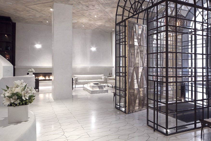 There’s the terrazzo floor created with resins poured into bronze inserts, the walls of seamless Carrara marble dust troweled on for the polish, and the ceilings of reclaimed, hand-dyed, oak beams.